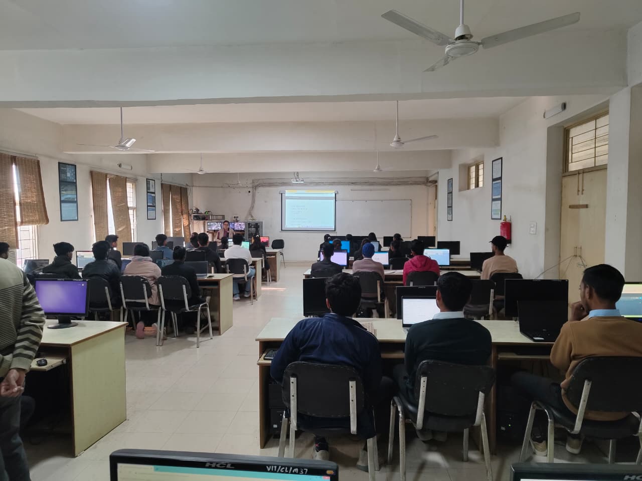 Students working at desktop computers during a lab session in the VCM computer lab